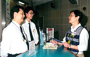 A labour inspector interviewing employees of public housing security service contractor to understand their employment conditions.